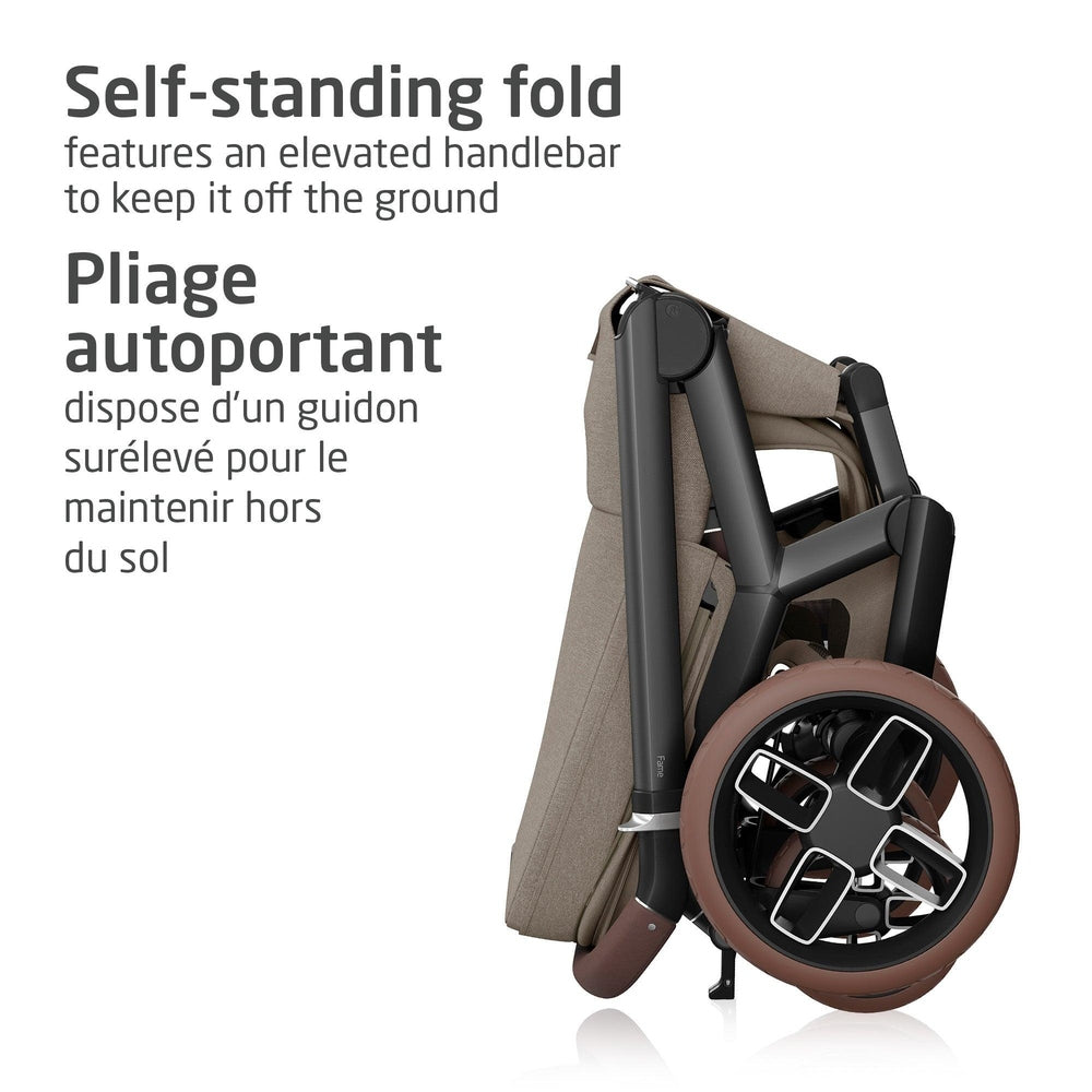Maxi-Cosi Fame Stroller folded self-standing with beige fabric and brown wheels, elevated handle keeping it off the ground.