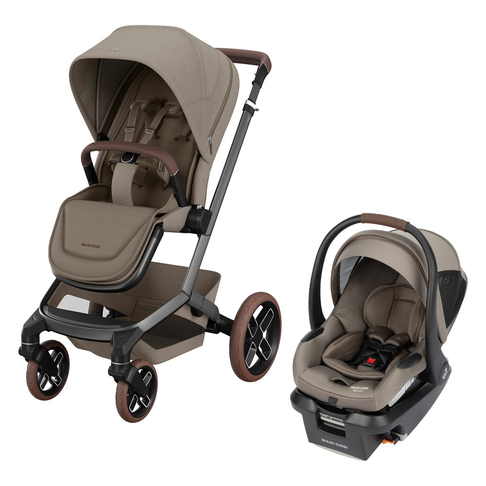 Beige Maxi-Cosi Fame stroller with brown leatherette handles and matching infant car seat on gray travel-system frame