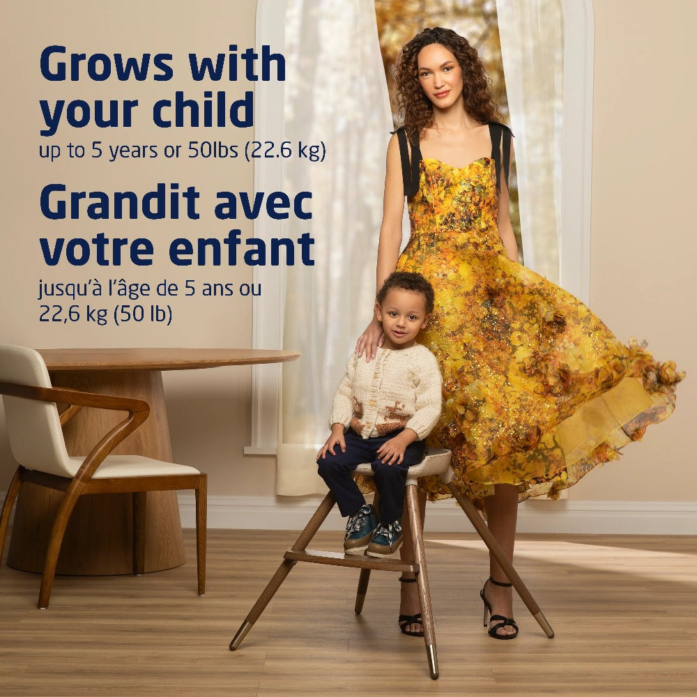 MAXI COSI Kiskadee 360 rotating high chair with child seated beside mother in a cozy dining room