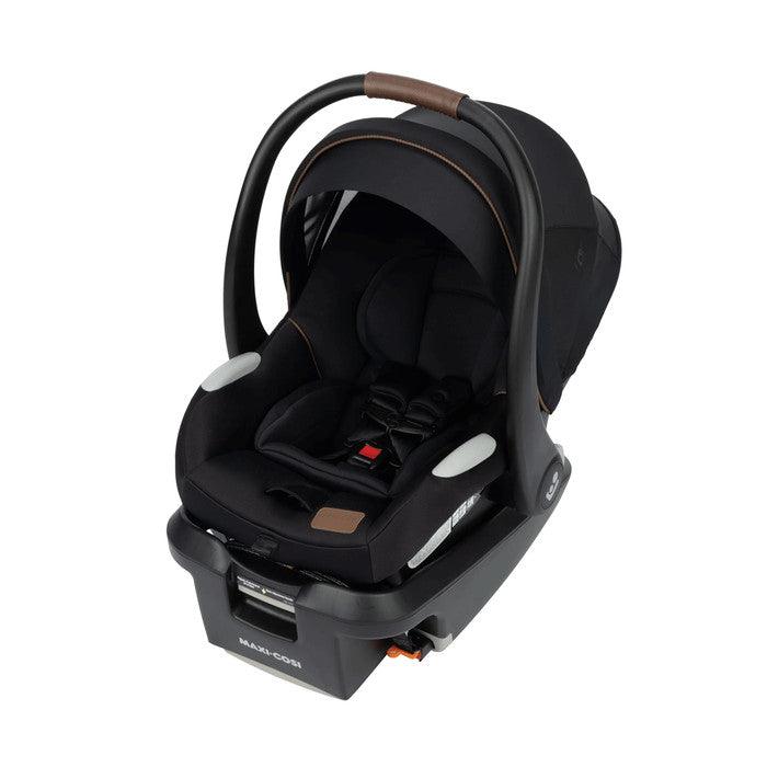 MAXI COSI Mico Luxe+ infant car seat in black with brown-accent handle, mounted on base for secure installation.