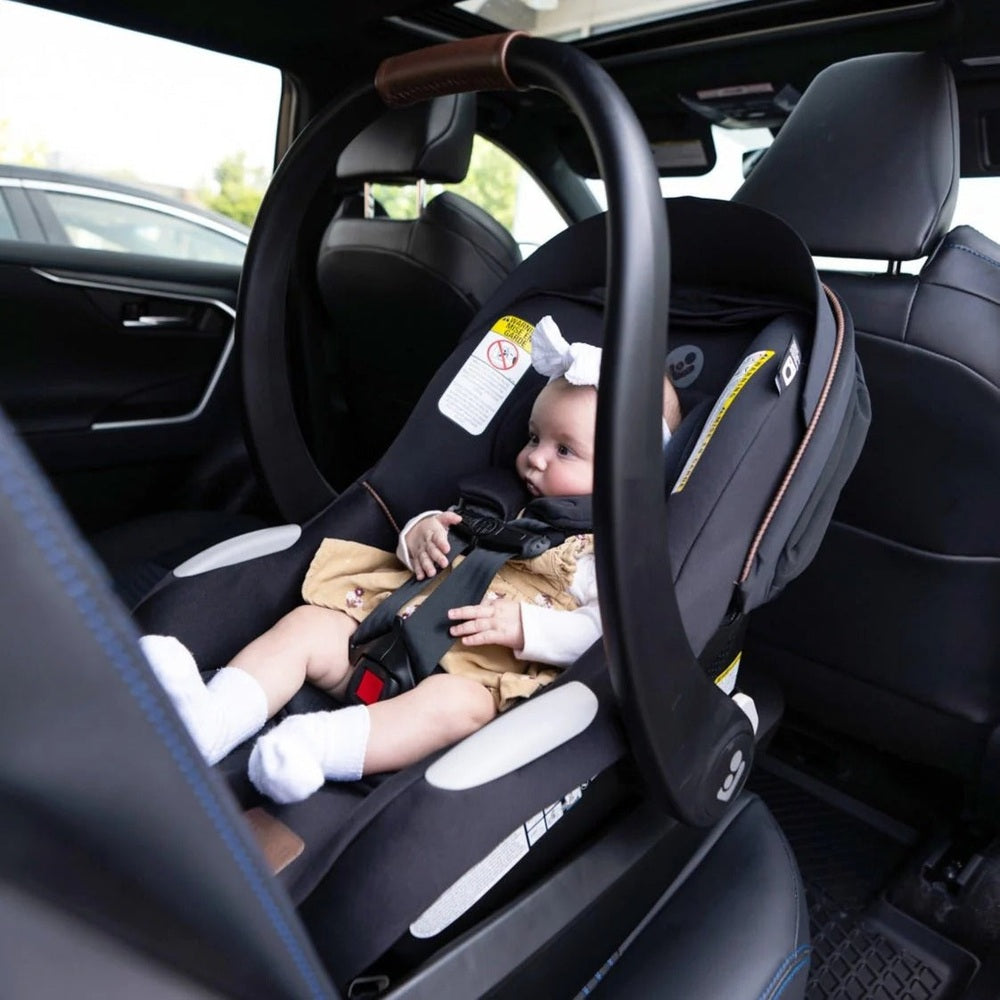 Maxi-Cosi Mico Luxe+ infant car seat in black with brown harness, installed in car.