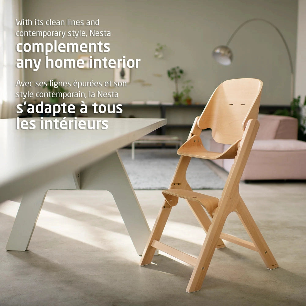 Maxi-Cosi Nesta 3-in-1 high chair in natural wood beside a white table in a bright, contemporary dining space