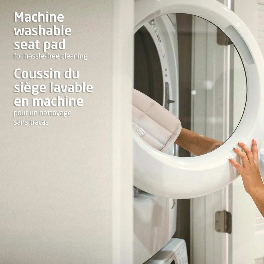 Maxi Cosi Nesta 3-In-1 High Chair with machine-washable seat pad, showing a hand removing the pad for cleaning.