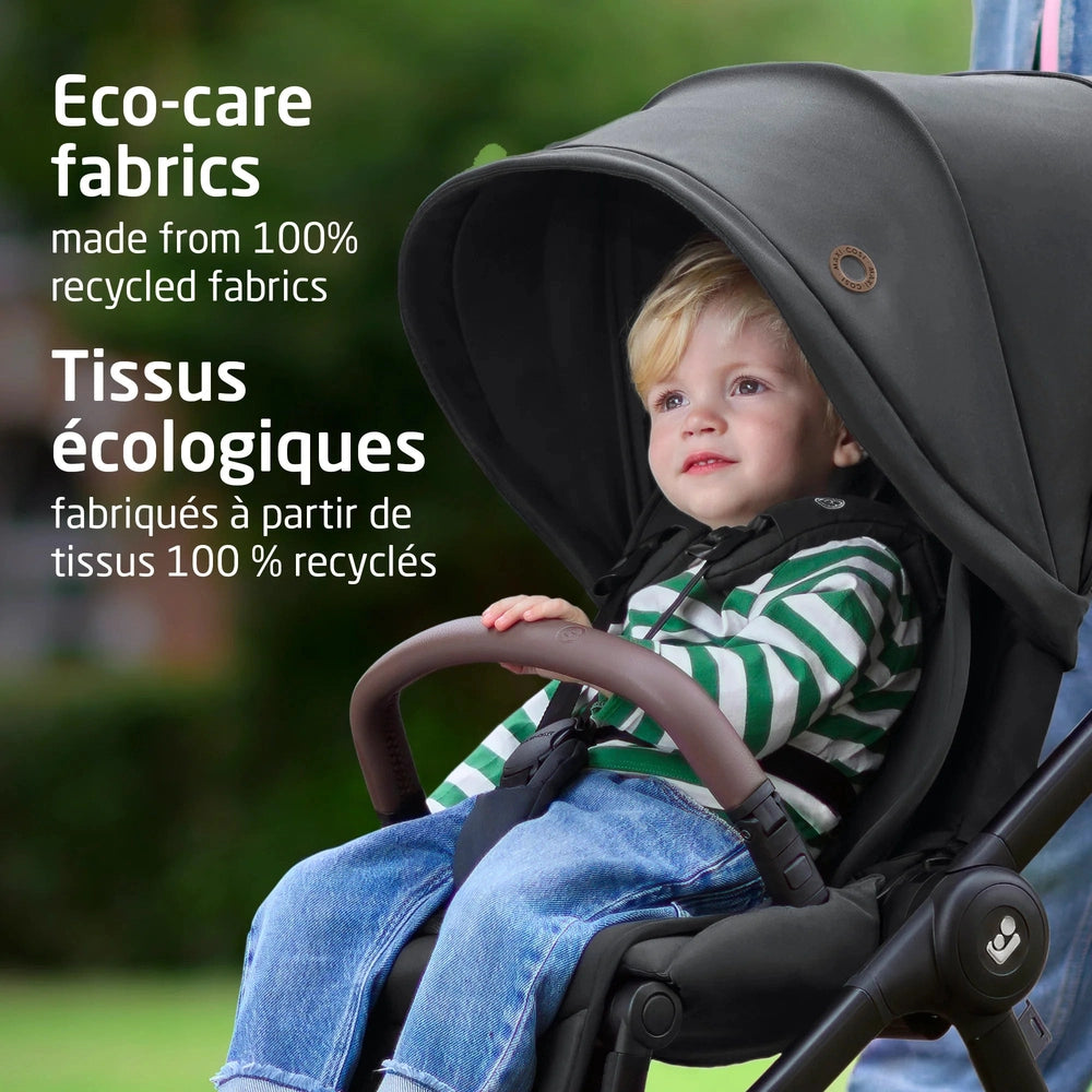 Maxi-Cosi Oxford Stroller & Mico Luxe+ Travel System in dark fabric; child sits secured under canopy, showcasing 100% recycled fabrics.