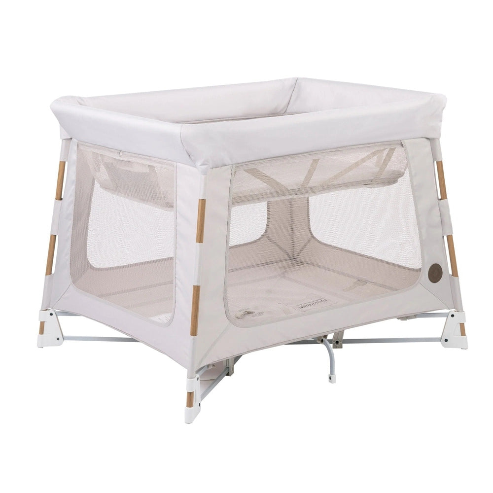 MAXI COSI Swift Playard in white with mesh sides and wood accents for baby bassinet