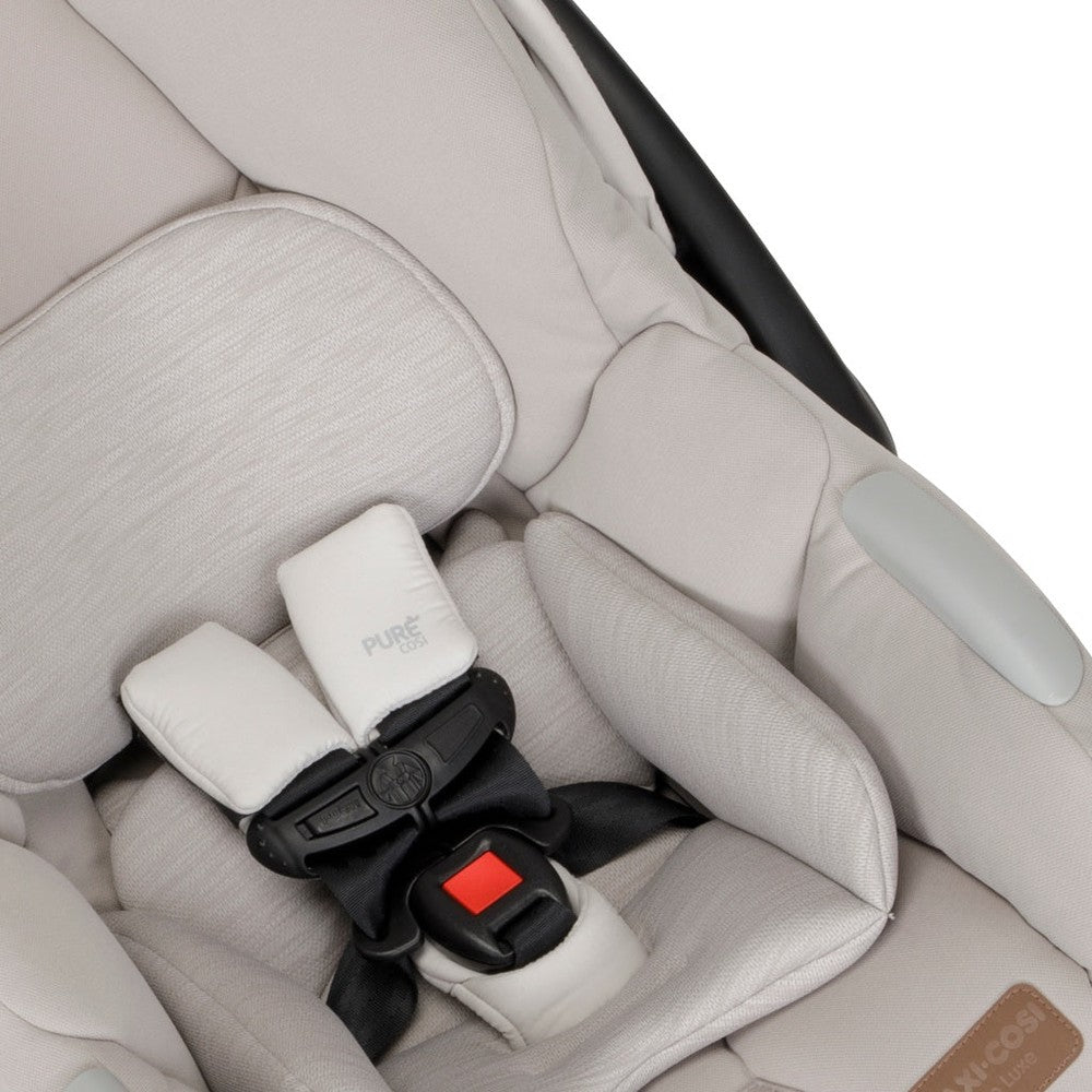 Maxi-Cosi Zelia Luxe 5-In-1 Modular Travel System stroller with light gray padding; 5-point harness buckled in.