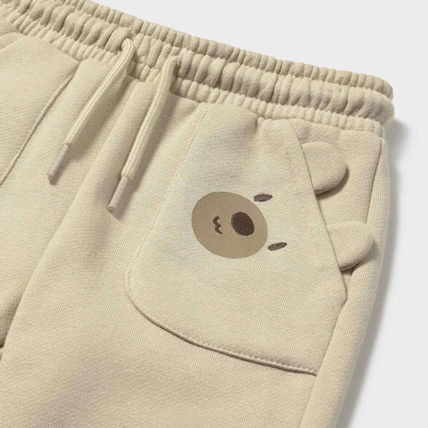 Mayoral fleece trousers Latte; beige baby pants with bear-face pocket detail.