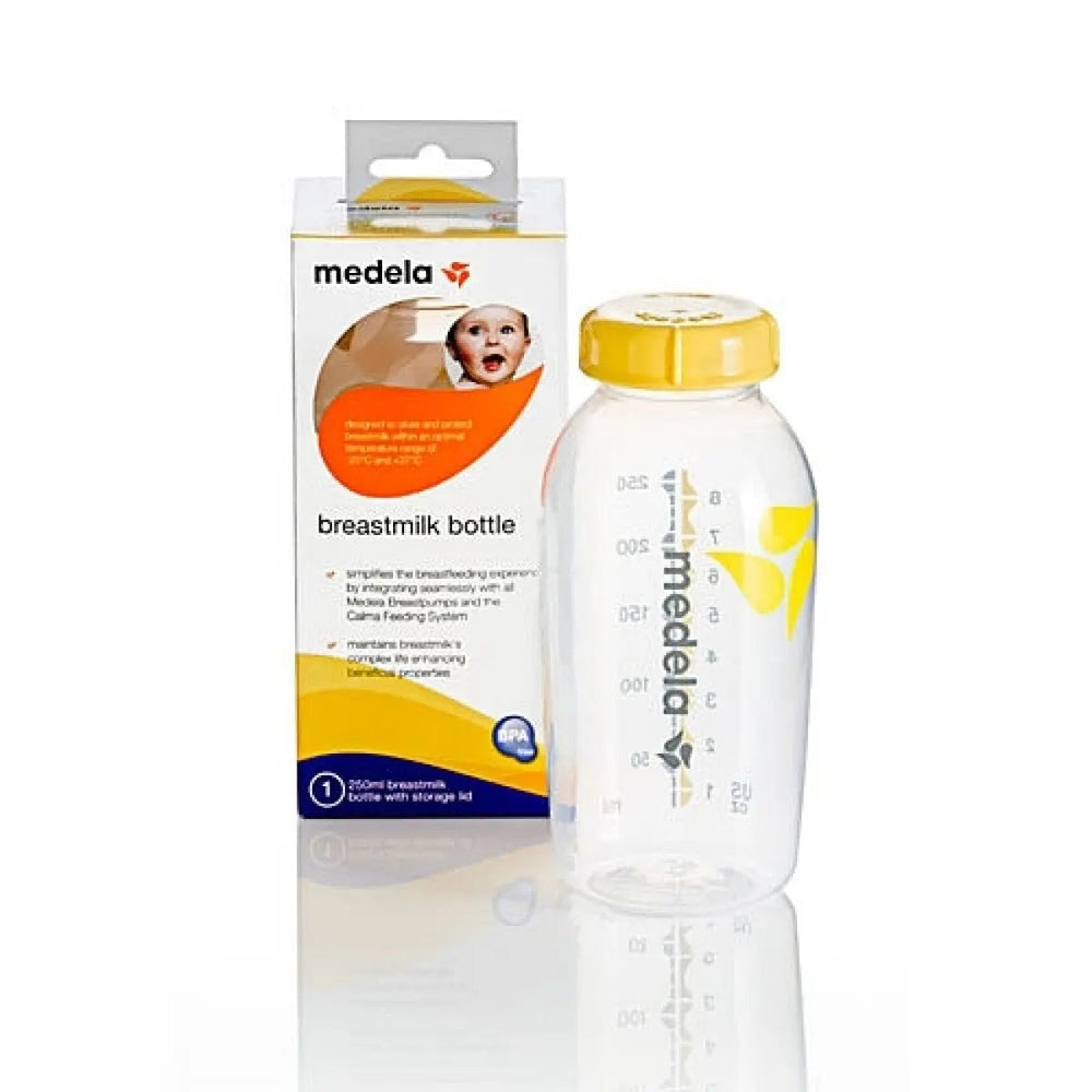 Medela Breastmilk Bottle with yellow cap, clear bottle standing upright beside its MEDELA packaging.