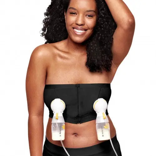 Medela Hands Free Pumping Bustier Black with dual bottle attachments secured to front as she pumps hands-free.