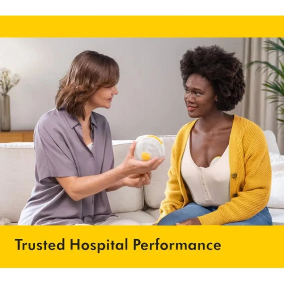 Medela Magic InBra Wearable Breast Pump in a cozy living room, showing its hands-free pumping capability.