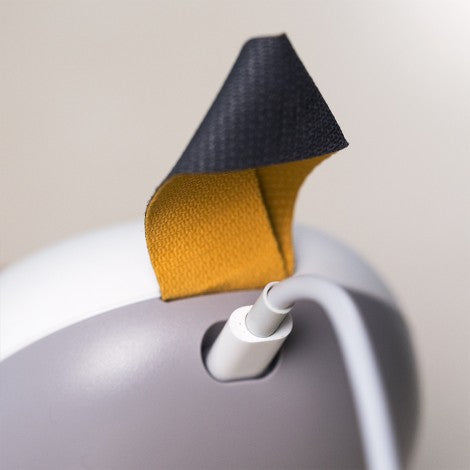 Medela Solo electric breast pump with yellow strap accent and gray body.