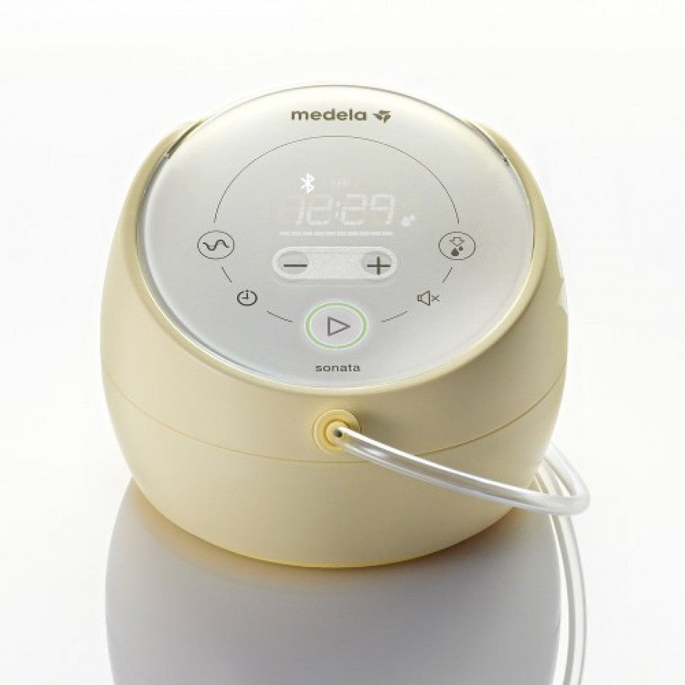 Medela Sonata Smart Breastpump in ivory with digital display and tubing connected.