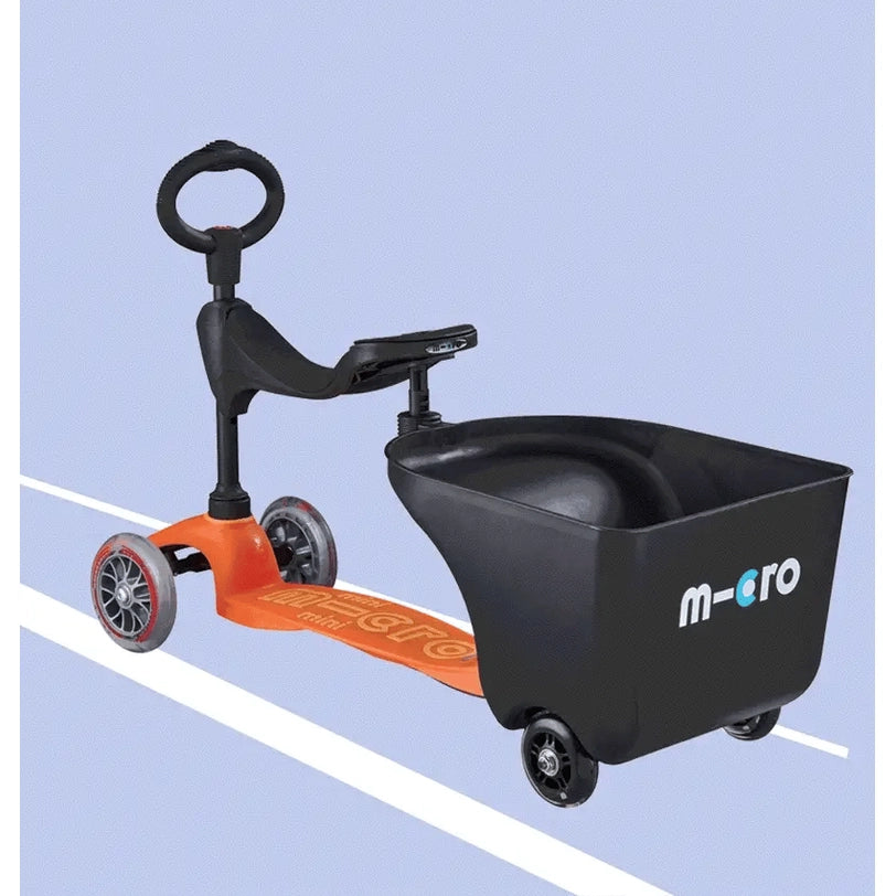 Micro Balance Bike Trailer with orange frame and black cargo tub, connected to a balance bike for preschoolers.