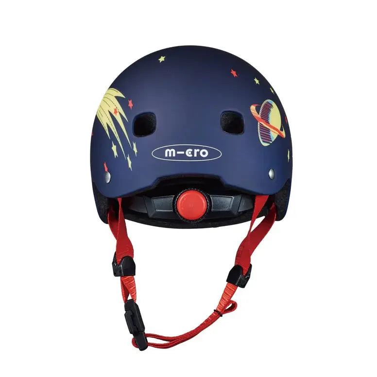 Micro Helmet V2 Rocket navy blue kids helmet featuring space graphics, with red chin strap hanging and adjustable dial.