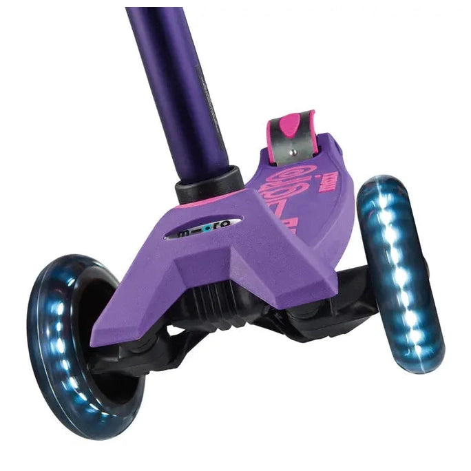 Micro Maxi Deluxe LED scooter in purple with glowing blue LED wheels, ready to ride.