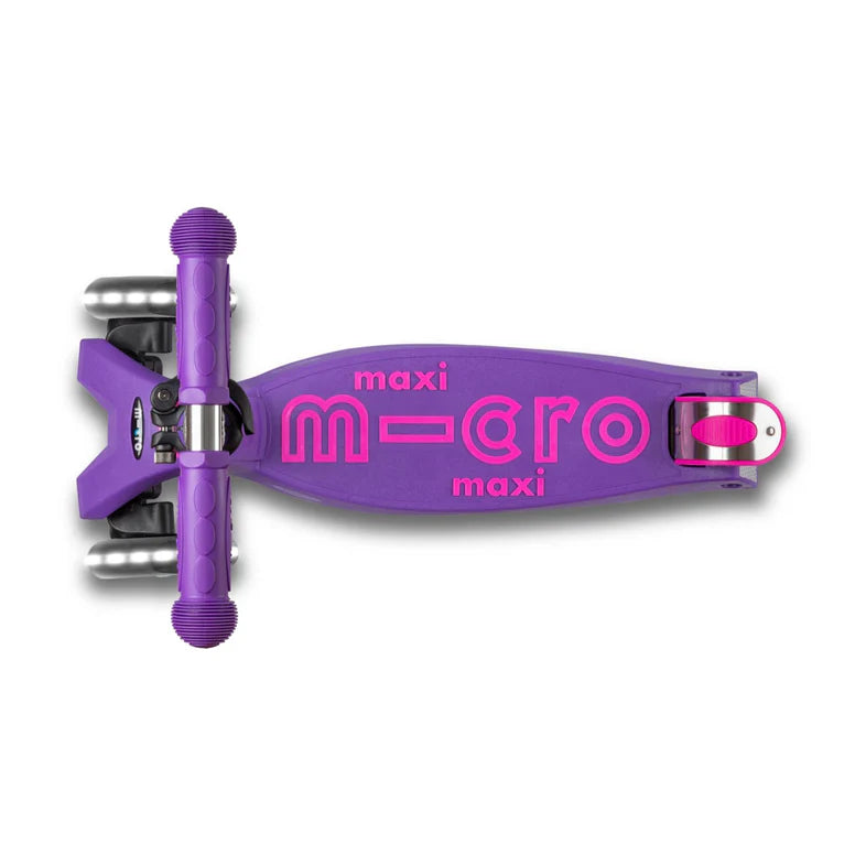 Micro Maxi Deluxe LED scooter in purple with pink MICRO logo on deck, ready to ride.