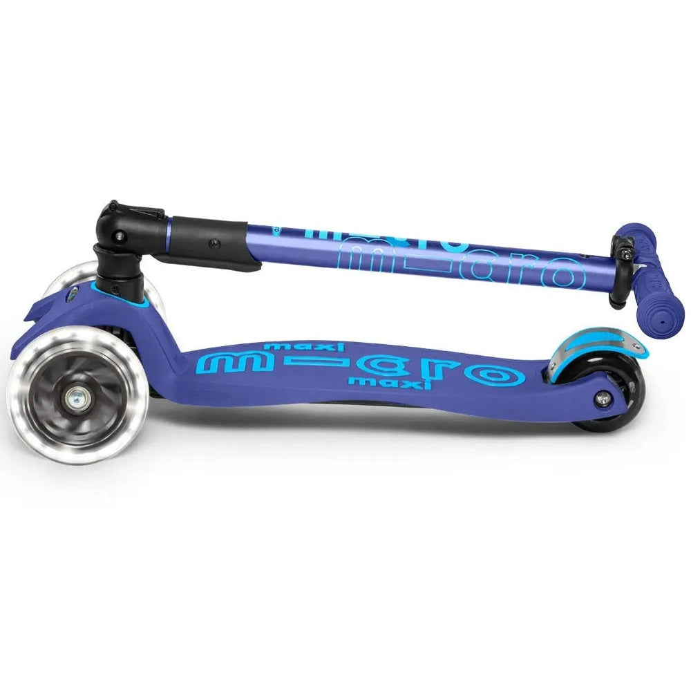 Micro Maxi Foldable Deluxe LED Scooter, blue with foldable stem shown collapsed over the deck for compact storage.