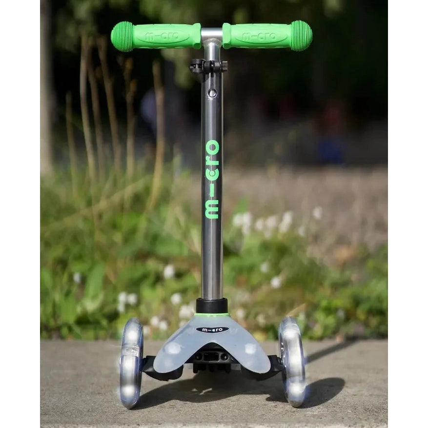 Micro Mini Deluxe Flux LED scooter with green grips and silver deck