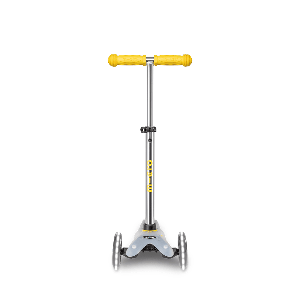 Micro Mini Deluxe Flux LED Scooter by MICRO with yellow grips and silver frame for kids