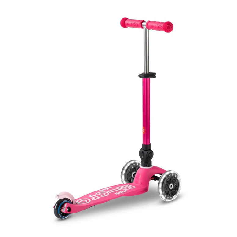 Micro Mini Deluxe Foldable LED Scooter pink three-wheel kids scooter with LED deck ready to roll.