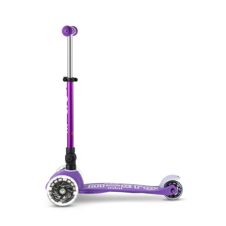 Micro Mini Deluxe Foldable LED Scooter in purple with extended adjustable stem and front LED wheel visible.