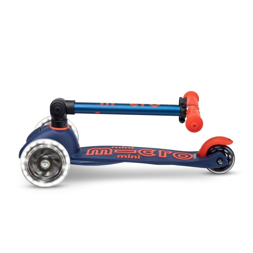 Micro Mini Deluxe Foldable LED Scooter blue with red grips and three wheels, compact for storage.