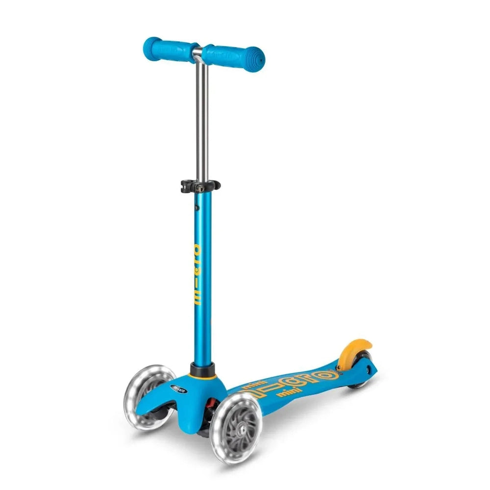 Micro Mini Deluxe LED Scooter in blue with three wheels and adjustable handlebars, ready for outdoor riding.