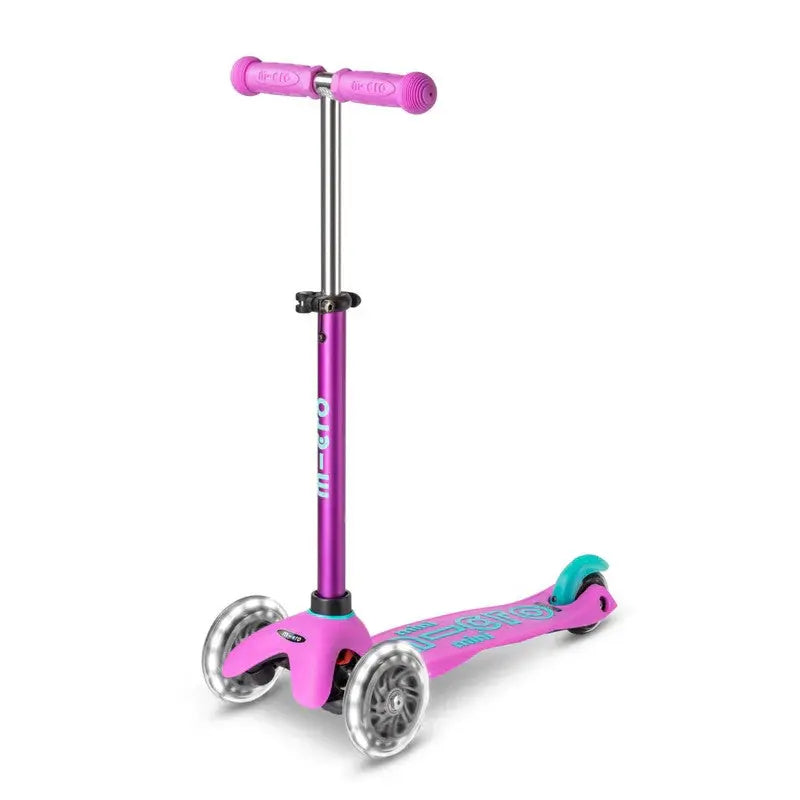 Micro Mini Deluxe LED scooter, pink deck with purple stem and 2 front wheels, by MICRO.
