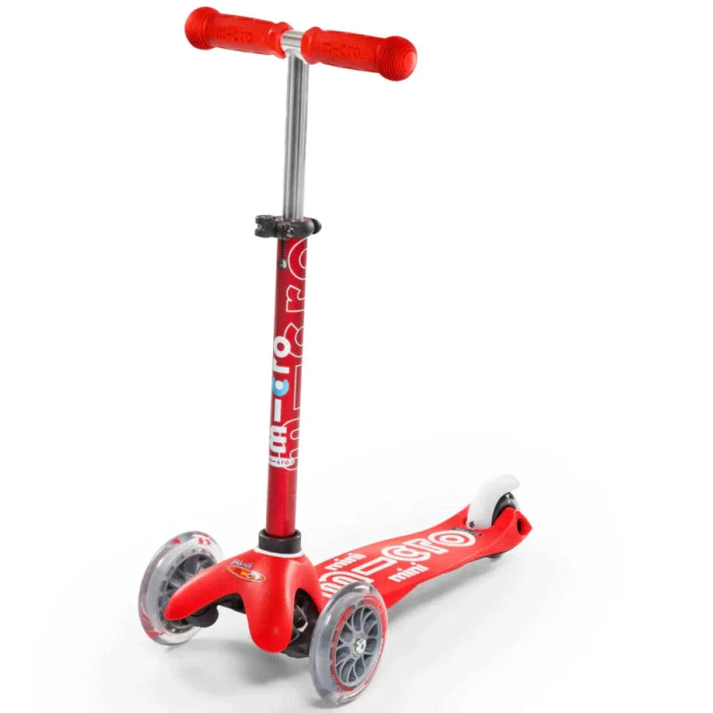 Micro Mini Deluxe Scooter red with T-bar, three-wheel design, stands ready for kids.