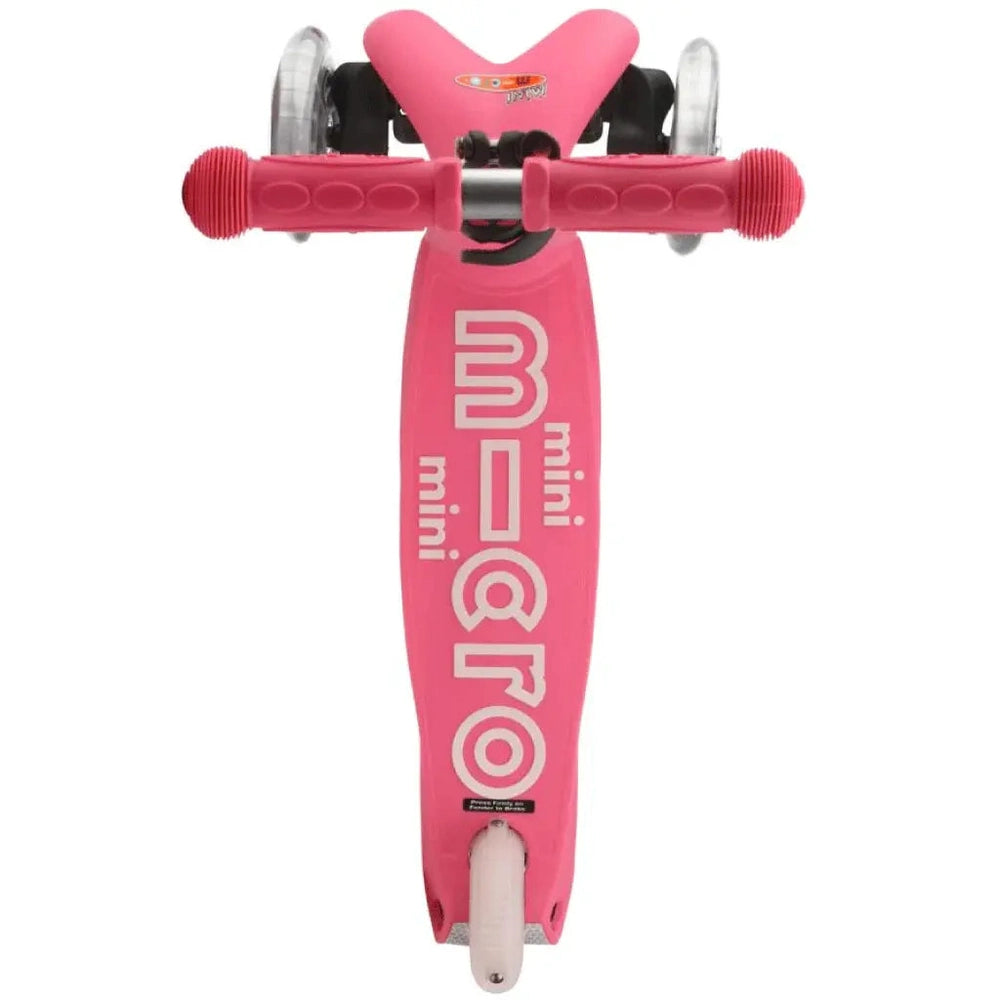 Micro Mini Deluxe Scooter pink with white wheels and grips, featuring a low deck ready to ride.