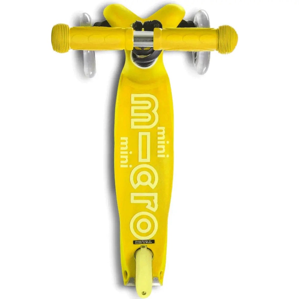 Micro Mini Deluxe Scooter, bright yellow kid-sized ride-on with visible handlebars and deck.