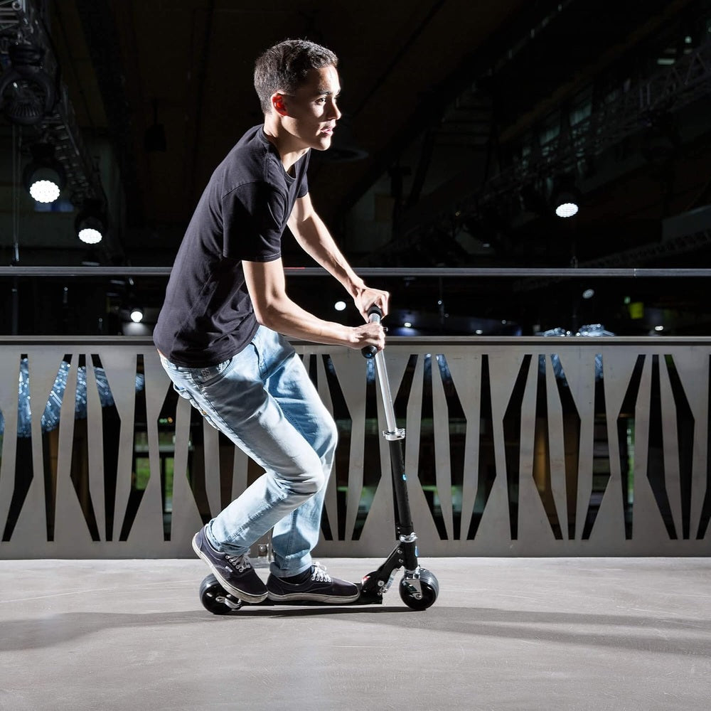 Micro Rocket Extra Wide Wheels Scooter Black being ridden by an adult indoors