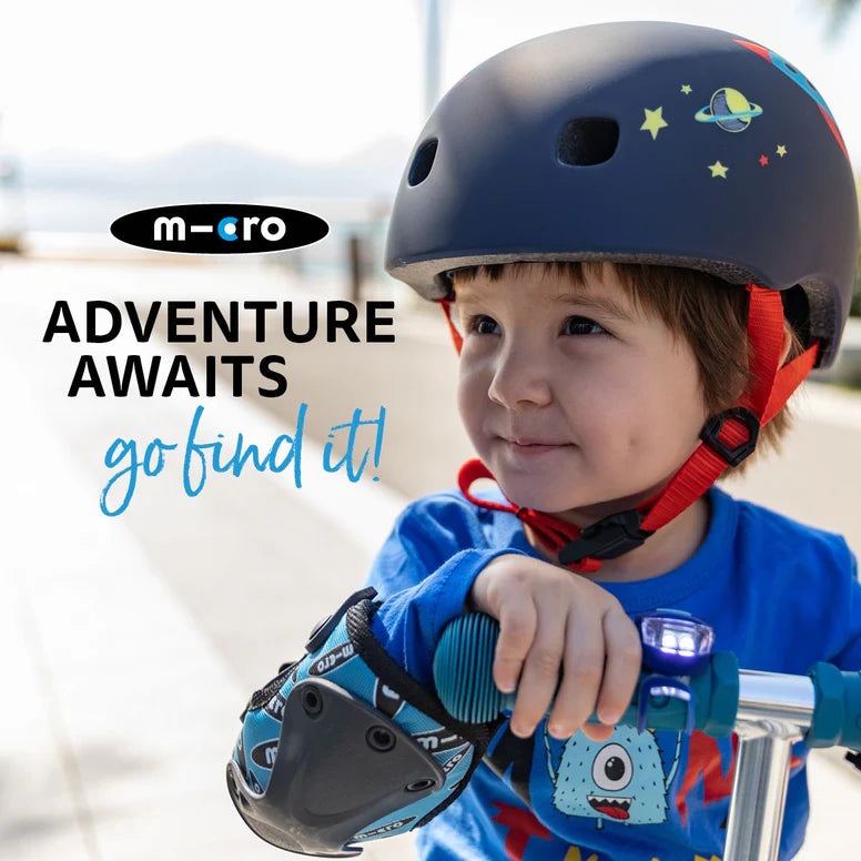 Micro Scooter by MICRO; child rider wearing a space-themed helmet on a blue scooter