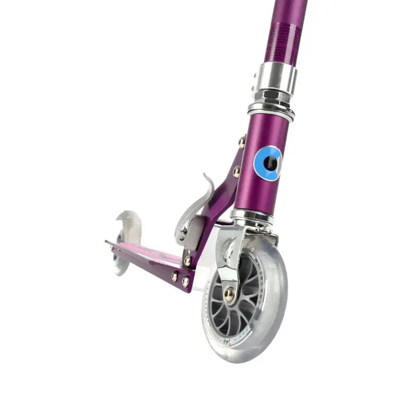 Micro Sprite LED Scooter by MICRO in purple with silver fittings; close-up of the front wheel.