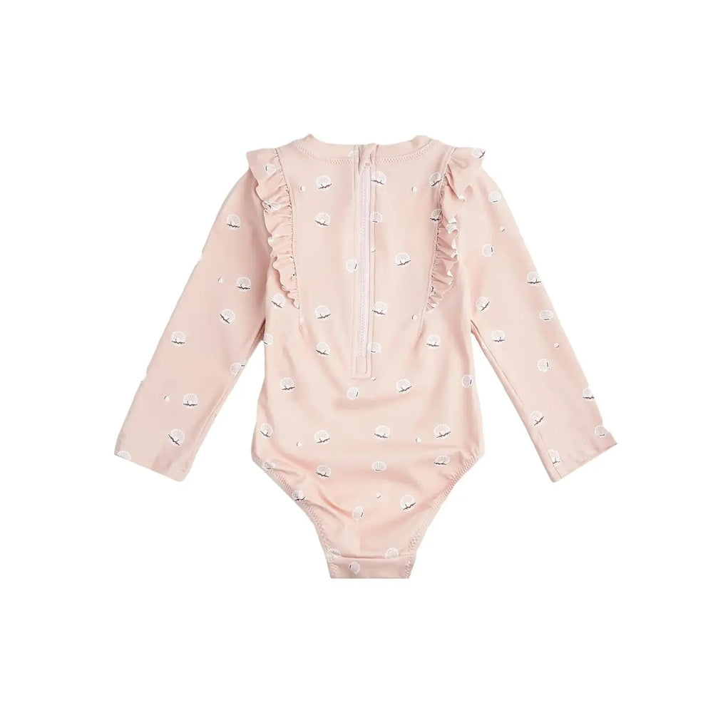 Miles The Label long-sleeve pink swimsuit with shell print, laid flat to show ruffled shoulders and back zipper.