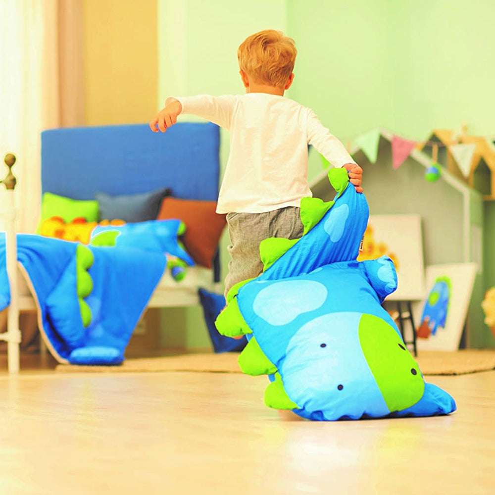 MILO & GABBY kids pillowcase featuring a blue dinosaur pillow on a colorful playroom floor