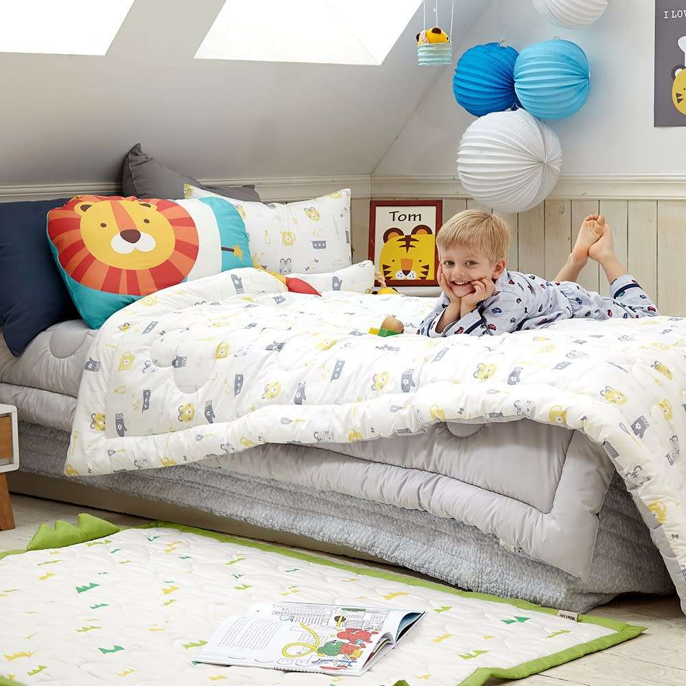 MILO & GABBY kids pillowcase set on a cozy bed with lion print and bright decorative cushions