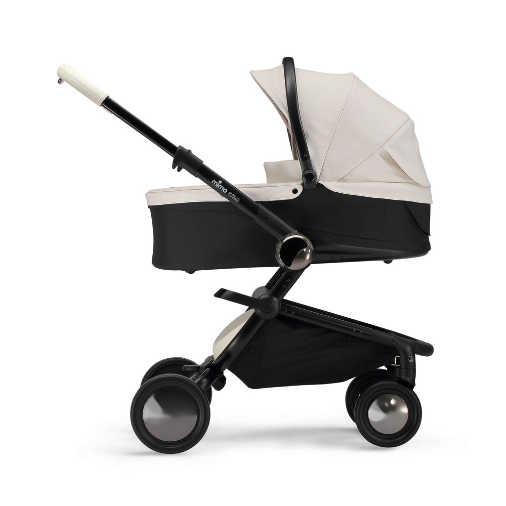 White Mima Creo bassinet for newborns, side view, compatible with the Mima Creo stroller.