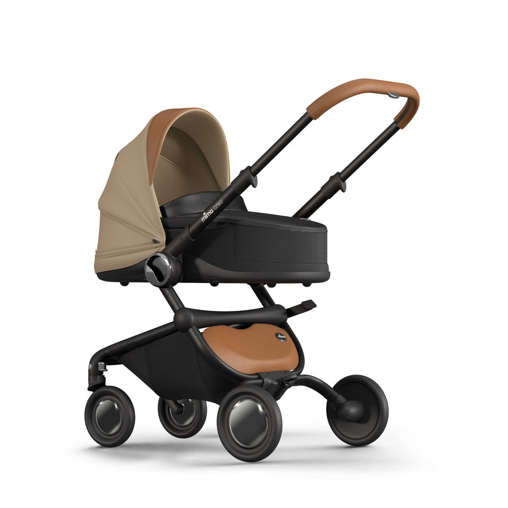 Mocha Mima Creo bassinet for newborns, left front view with canopy, compatible with the Mima Creo stroller.