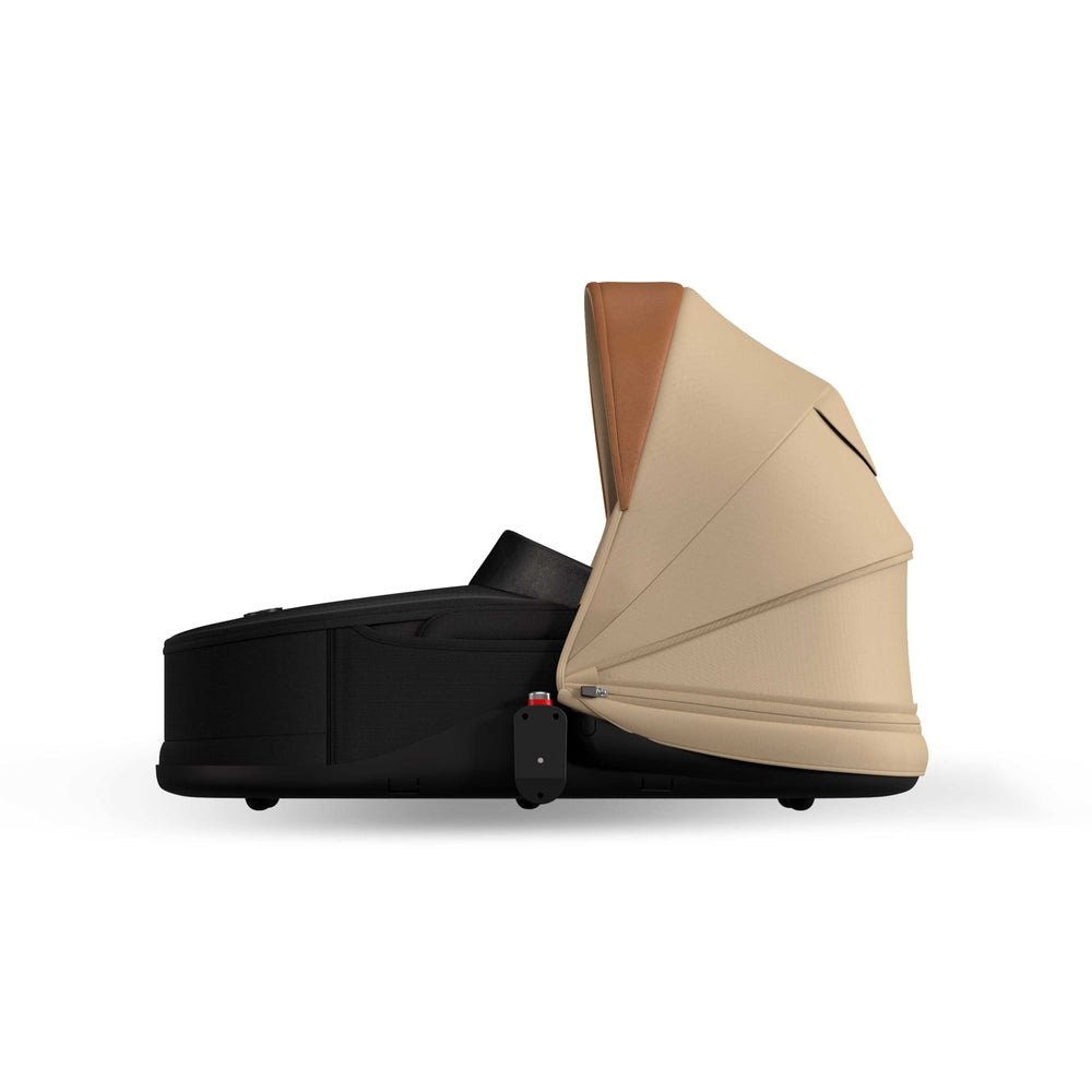 Mocha Mima Creo bassinet, standalone side view with shared canopy, compatible with the Mima Creo stroller.