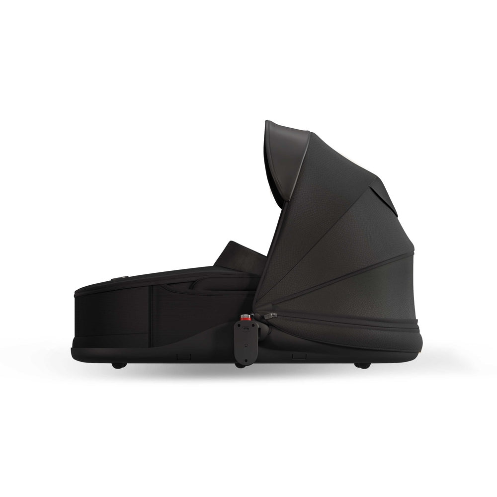 Black Mima Creo bassinet, standalone side view with shared canopy, compatible with the Mima Creo stroller.