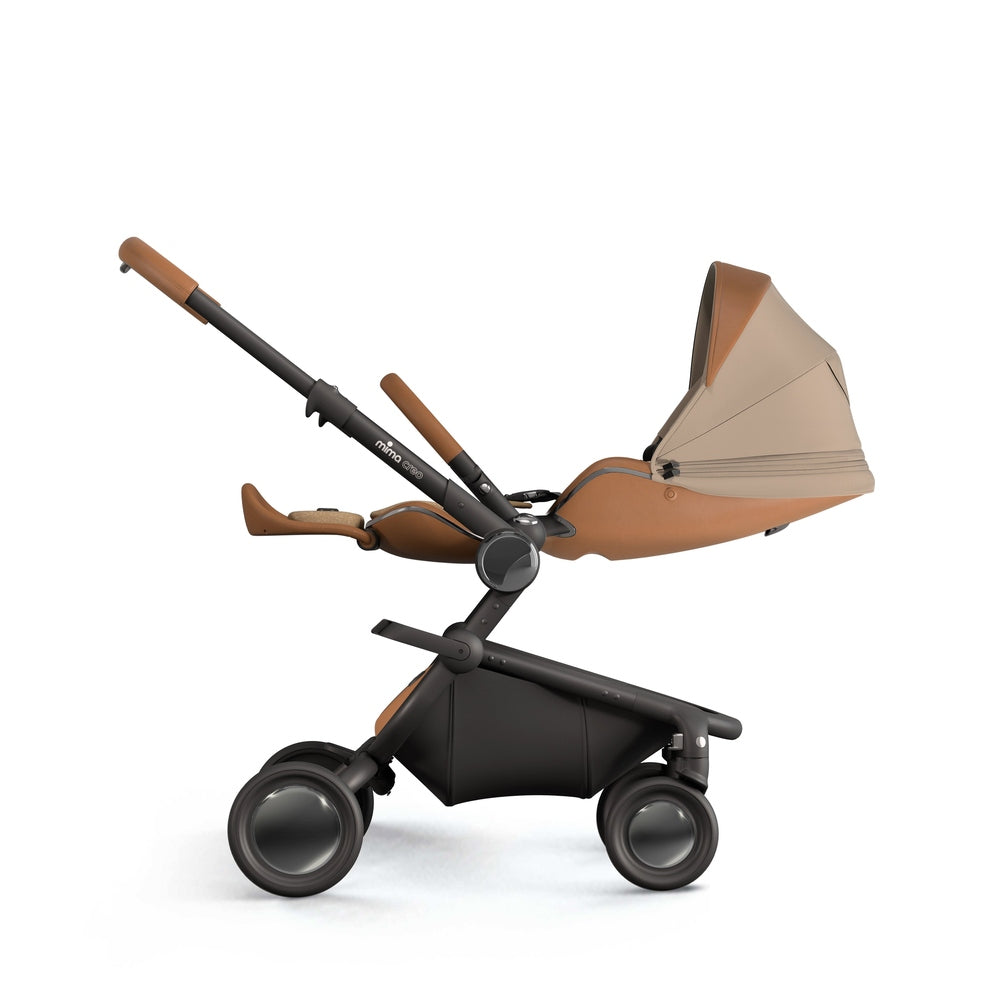 Mima Creo Stroller in tan leatherette with black chassis and large wheels, bassinet attached.