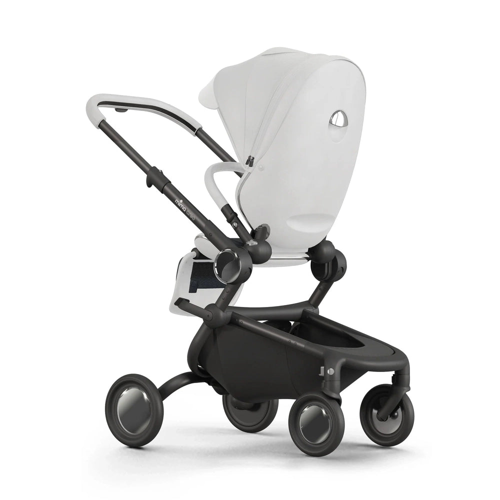 Mima Creo stroller with white bassinet and black chassis, four-wheel setup for smooth city strolling.
