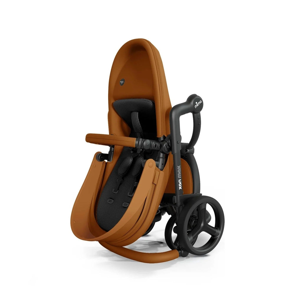 Mima Xari Max Stroller in tan, folded with handle extended for compact, travel-ready use.