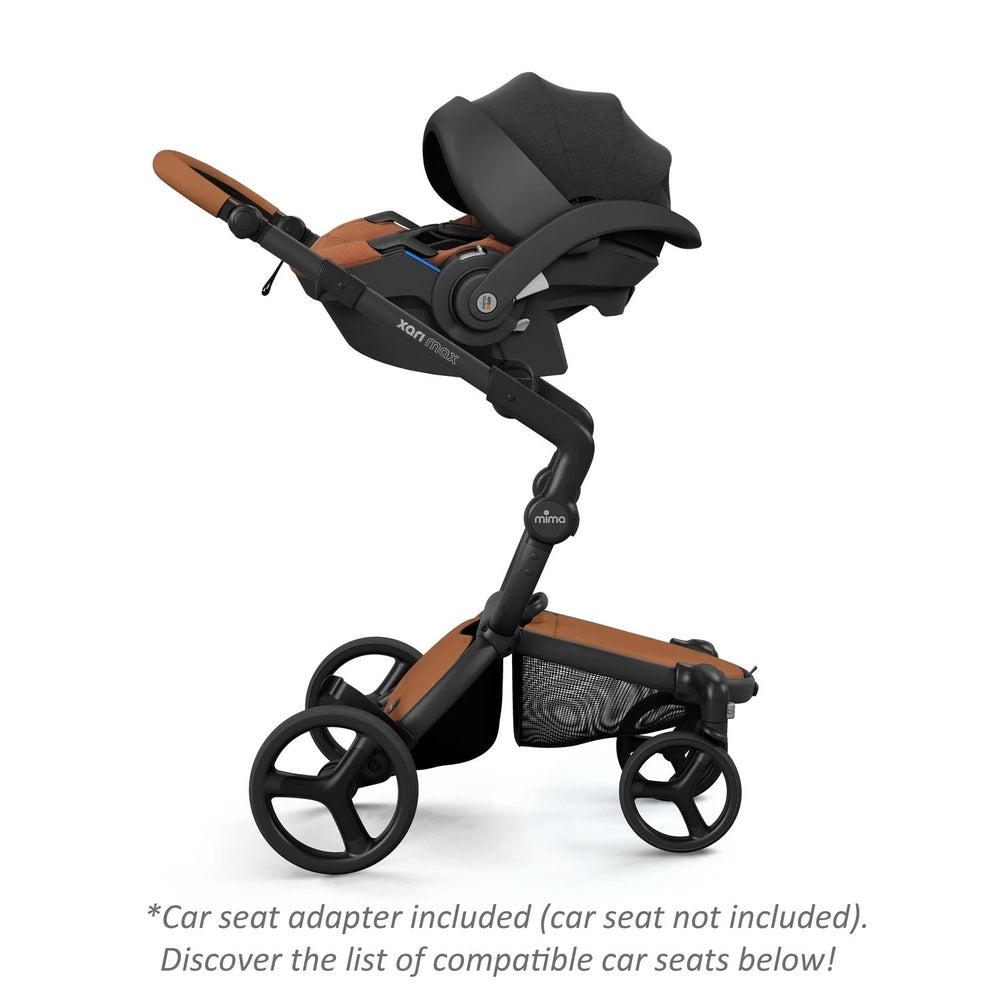 Mima Xari Max Stroller in black frame with brown accents and bassinet, large wheels and under-basket.