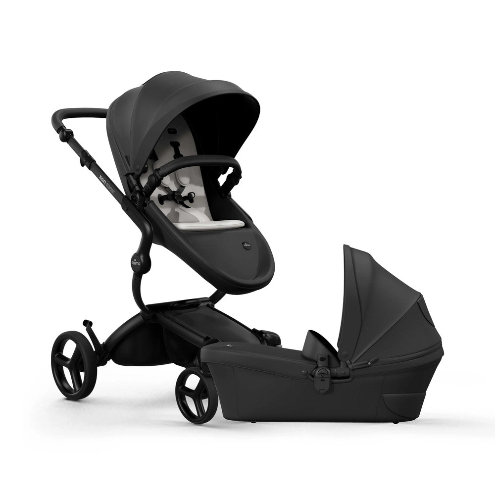 Mima Xari Max Stroller & Bassinet Collection black stroller with canopy and bassinet attachment.