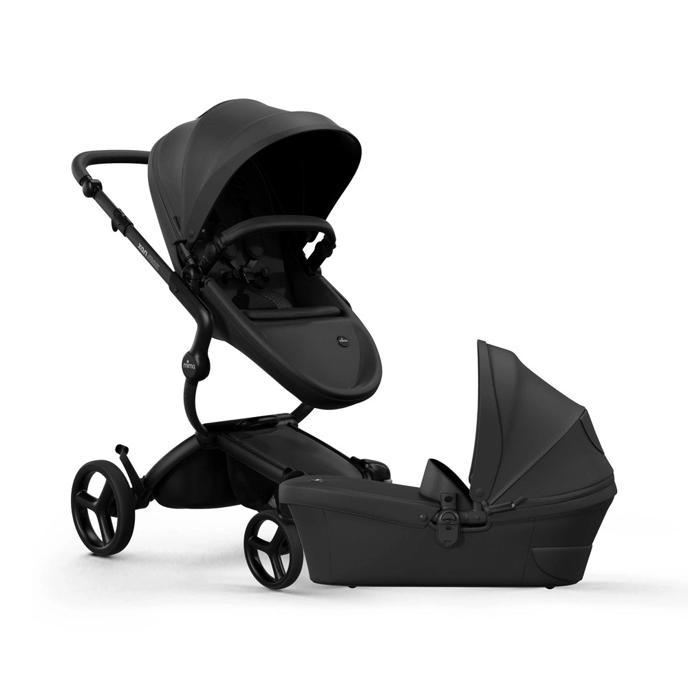 Mima Xari Max Stroller in black with bassinet, showcasing modular chassis and canopy.