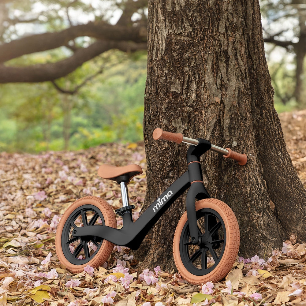 Mima Zoom Lite Balance Bike in Black park scene
