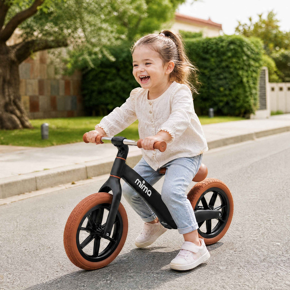 Mima Zoom Lite Balance Bike black toddler riding lifestyle feature