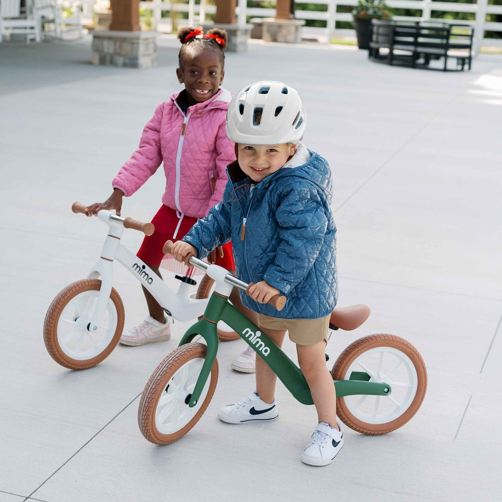 Mima Zoom Lite Balance Bike in Green children riding outdoors